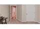 Carpeted hallway leads to another room, next to a closed 6 panel door at 4235 Crestwood Bend Cir, Buford, GA 30518