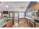 Open concept kitchen featuring wood floors, a breakfast bar, a dining table, and stainless steel appliances at 4235 Crestwood Bend Cir, Buford, GA 30518