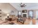 Bright living room with hardwood floors, fireplace, and comfortable seating at 4235 Crestwood Bend Cir, Buford, GA 30518