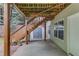 Covered patio featuring access to a storage shed and staircase at 4235 Crestwood Bend Cir, Buford, GA 30518