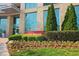 Entrance to the Manhattan building features lush landscaping and clear windows at 4561 Olde Perimeter Way # 608, Dunwoody, GA 30346