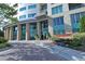 Beautiful building entrance with brick pavers, manicured landscaping and glass-walled lobby at 4561 Olde Perimeter Way # 608, Dunwoody, GA 30346