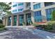 Elegant entrance with glass doors and windows, complemented by lush landscaping at 4561 Olde Perimeter Way # 608, Dunwoody, GA 30346