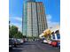 A contemporary high-rise building with a parking lot, stores and vibrant blue skies at 4561 Olde Perimeter Way # 608, Dunwoody, GA 30346