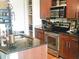 Modern kitchen features stainless steel appliances, granite countertops, and wood cabinets at 4561 Olde Perimeter Way # 608, Dunwoody, GA 30346