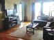 Bright living room featuring hardwood floors, a cozy sofa, and a view to the balcony at 4561 Olde Perimeter Way # 608, Dunwoody, GA 30346