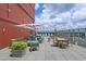 Rooftop terrace with cozy seating, an umbrella and stunning city views, perfect for relaxing and entertaining at 4561 Olde Perimeter Way # 608, Dunwoody, GA 30346