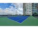 Community blue tennis court surrounded by high-rise buildings at 4561 Olde Perimeter Way # 608, Dunwoody, GA 30346