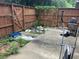 Fenced backyard needing maintenance, featuring a concrete patio with an elliptical, grill, and climbing ivy at 6354 Shannon Pkwy # 26C, Union City, GA 30291