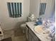 Modest bathroom featuring a cream colored sink and toilet next to a neutral speckled countertop and white cabinets at 6354 Shannon Pkwy # 26C, Union City, GA 30291