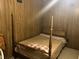 Bedroom featuring a four-poster bed and wood-paneled walls at 6354 Shannon Pkwy # 26C, Union City, GA 30291