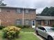 Brick multifamily with gray shutters, trimmed bushes, and a gray car parked in front at 6354 Shannon Pkwy # 26C, Union City, GA 30291