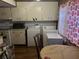 Kitchen with range, microwave, and washer/dryer near table and chairs at 6354 Shannon Pkwy # 26C, Union City, GA 30291