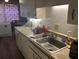 Kitchen sink with adjacent counter space and white cabinets, and an adjacent dining area at 6354 Shannon Pkwy # 26C, Union City, GA 30291