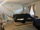 Living room featuring stairs, front door, couch with cover, and window with curtain at 6354 Shannon Pkwy # 26C, Union City, GA 30291