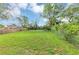 Spacious backyard features lush green grass and chain link fence with shade trees along the border at 1338 Georgia Ave, Atlanta, GA 30344