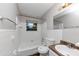 Bright bathroom with white tile, a tub, and vanity sink at 1338 Georgia Ave, Atlanta, GA 30344
