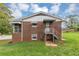 Rear view of the brick home featuring covered access to an external entrance at 1338 Georgia Ave, Atlanta, GA 30344