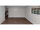 Inviting living room with hardwood flooring, neutral gray walls, and natural light streaming through the window at 1338 Georgia Ave, Atlanta, GA 30344