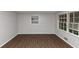 Bright living room with new hardwood flooring, neutral gray walls, and natural light from two large windows at 1338 Georgia Ave, Atlanta, GA 30344