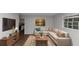 Comfortable living room features plush sofa, stylish décor, hardwood floors, and a view into the kitchen at 1338 Georgia Ave, Atlanta, GA 30344