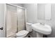 Bathroom featuring a shower with sliding doors, toilet, and pedestal sink at 160 Northside Ave, Dallas, GA 30157