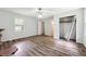 Bright bedroom with wood-look floors, featuring ample closet space and a window overlooking the yard at 160 Northside Ave, Dallas, GA 30157