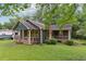 Cozy home with a covered front porch, accented by mature landscaping and an inviting, well-kept lawn at 160 Northside Ave, Dallas, GA 30157