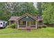 Charming home featuring a cozy front porch, complemented by lush greenery, and a neatly maintained lawn at 160 Northside Ave, Dallas, GA 30157