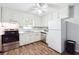 Bright kitchen featuring white cabinets, stainless steel appliances, and ample counter space for cooking at 160 Northside Ave, Dallas, GA 30157