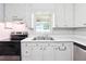Efficient kitchen featuring white cabinets, a stainless steel sink, and a functional layout for easy meal preparation at 160 Northside Ave, Dallas, GA 30157