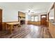 Warm living room boasting wood-look floors, a cozy brick fireplace, and a seamless flow to the kitchen at 160 Northside Ave, Dallas, GA 30157
