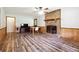 Inviting living room featuring wood-look floors, brick fireplace, and ample space for relaxing and entertaining at 160 Northside Ave, Dallas, GA 30157