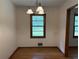 Dining room with hardwood floors, chandelier, and window with backyard view at 1791 Fairview Sw Dr, Austell, GA 30106