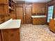Spacious kitchen showcasing wood paneling, built-in cabinets, and tile floors at 1791 Fairview Sw Dr, Austell, GA 30106