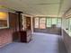 Spacious screened-in porch with carpet flooring, brick walls, and lots of windows at 1791 Fairview Sw Dr, Austell, GA 30106