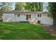 Backyard view showcasing the home's exterior and expansive grassy lawn at 2595 Elkhorn Dr, Decatur, GA 30034