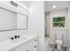Modern bathroom featuring a sleek vanity with quartz countertop and marble tile accents at 2595 Elkhorn Dr, Decatur, GA 30034