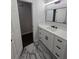 Updated bathroom with white vanity, black hardware, and marble-patterned tile flooring at 2595 Elkhorn Dr, Decatur, GA 30034