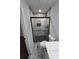 Elegant bathroom with a marble tiled shower featuring black frame and black hardware at 2595 Elkhorn Dr, Decatur, GA 30034
