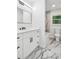 Stylish bathroom featuring marble tile, a sleek vanity with black hardware, and great lighting at 2595 Elkhorn Dr, Decatur, GA 30034
