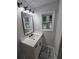 Charming bathroom boasts updated vanity with quartz counters and a view to the yard at 2595 Elkhorn Dr, Decatur, GA 30034