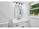 Bright bathroom features a modern vanity with white countertops and a decorative mirror at 2595 Elkhorn Dr, Decatur, GA 30034