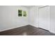 Cozy bedroom featuring hardwood floors, a window, and a closet at 2595 Elkhorn Dr, Decatur, GA 30034