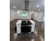 A gourmet kitchen features an island cooktop with modern cabinetry and finishes at 2595 Elkhorn Dr, Decatur, GA 30034