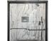 Close-up of a glass-enclosed shower with marble tile and modern black hardware at 2595 Elkhorn Dr, Decatur, GA 30034