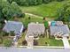 A neighborhood features mature trees, well-maintained lawns, and a shared green space at 580 River Valley Dr, Dacula, GA 30019