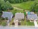 Aerial view showing the rear of houses, lush green lawns, and inviting swimming pool at 580 River Valley Dr, Dacula, GA 30019