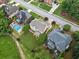 Aerial view showing the rear of houses, a lush green lawn, and inviting swimming pool at 580 River Valley Dr, Dacula, GA 30019