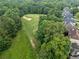 Aerial view of a golf course surrounded by lush greenery and residential homes in a suburban neighborhood at 580 River Valley Dr, Dacula, GA 30019
